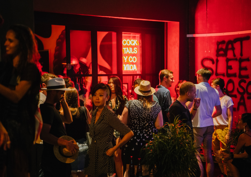 Customers standing outside a bar