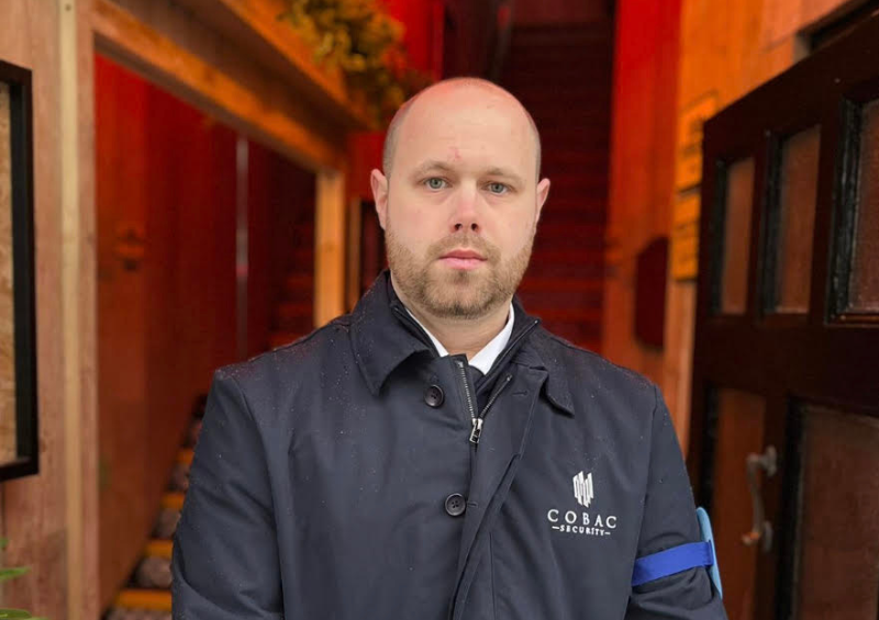 Cobac Security door supervisor stands at the entrance to a hospitality venue