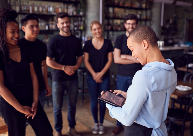 Restaurant manager talking to her staff