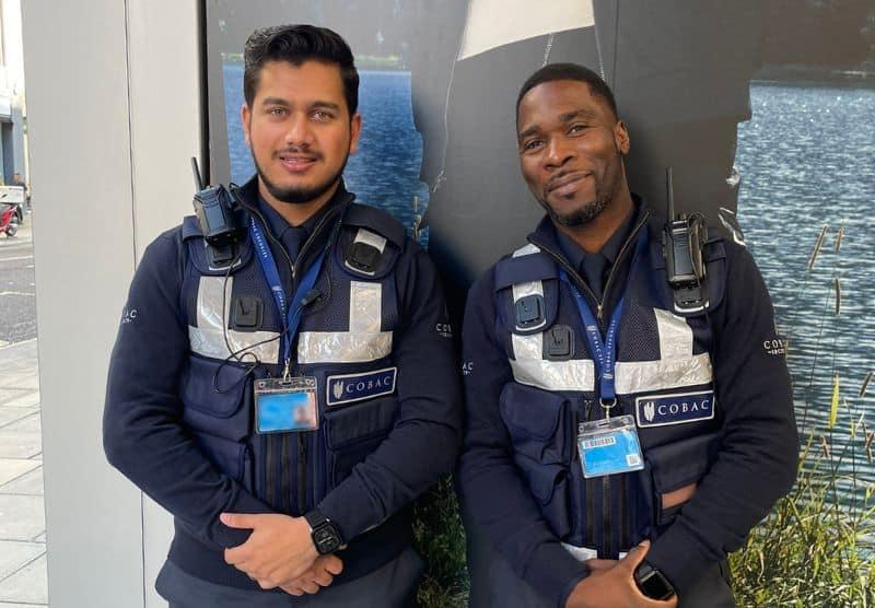Two Cobac security officers smiling whilst on shift